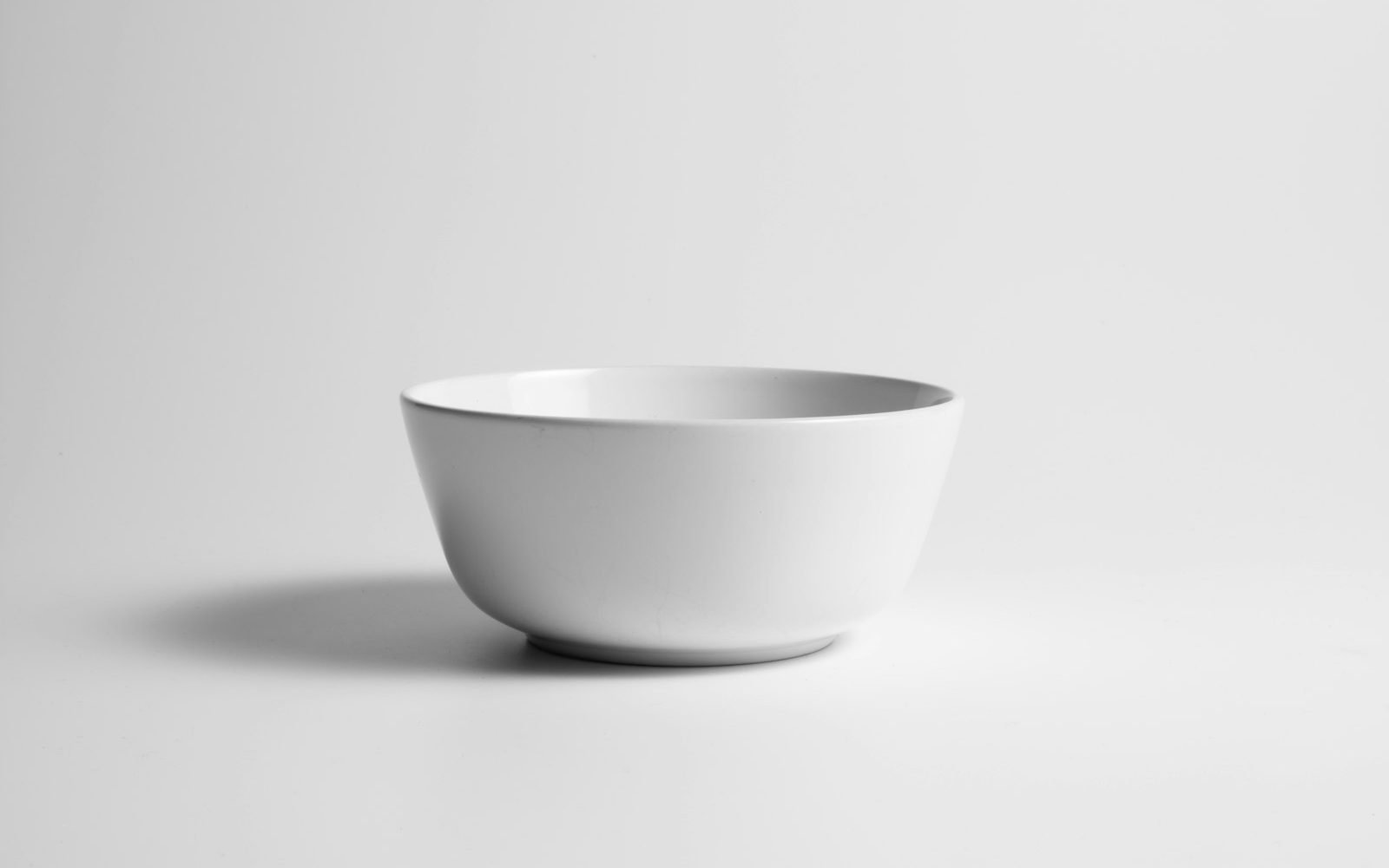 Fresh green tea leaves in a white bowl