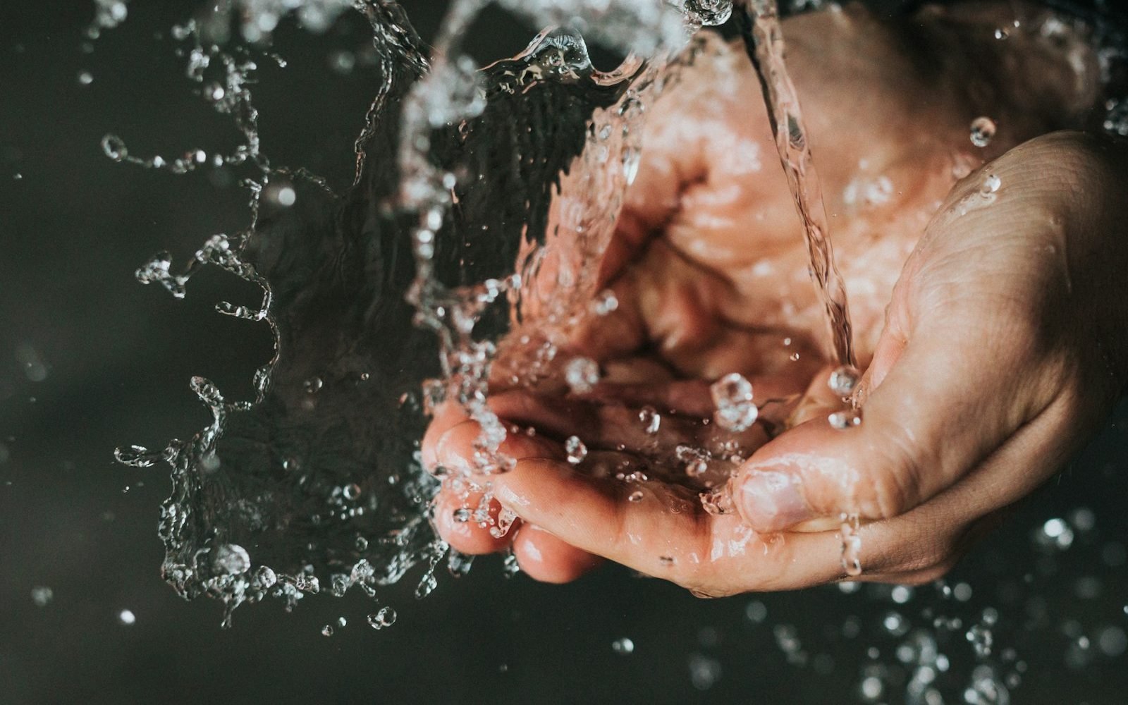 Hands mixing cleanser with water